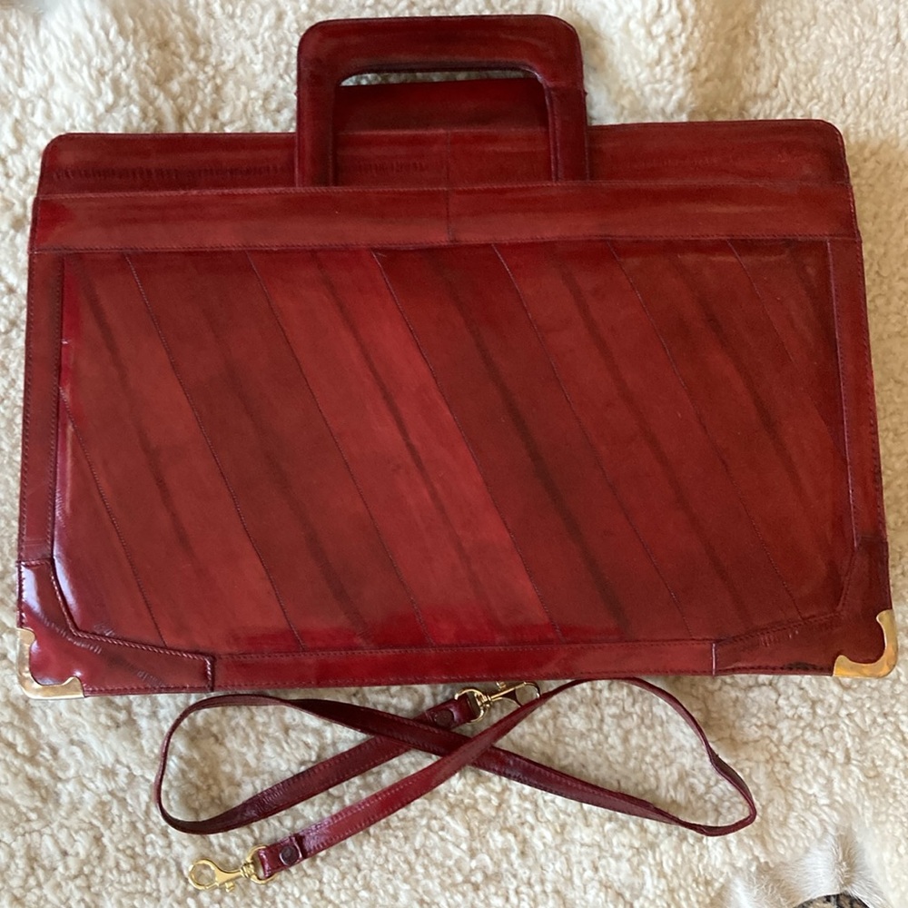 Vintage eel skin briefcase with retractable handles and detachable strap.
